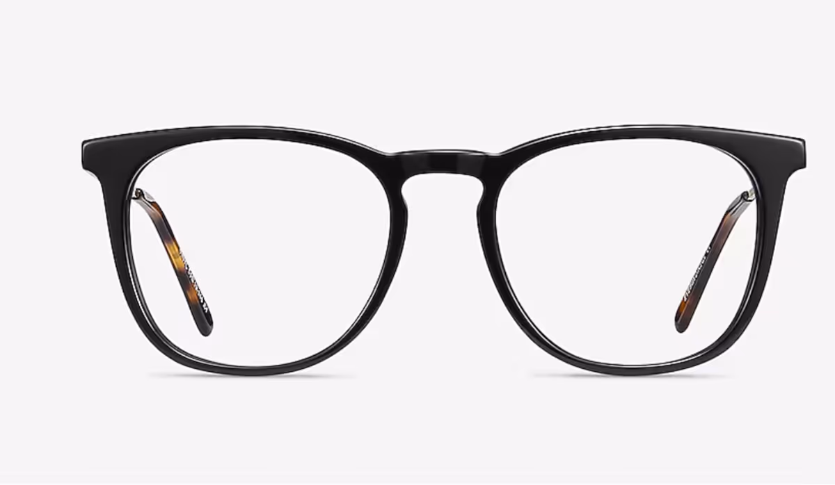 Black rimmed eyeglasses on a white surface.