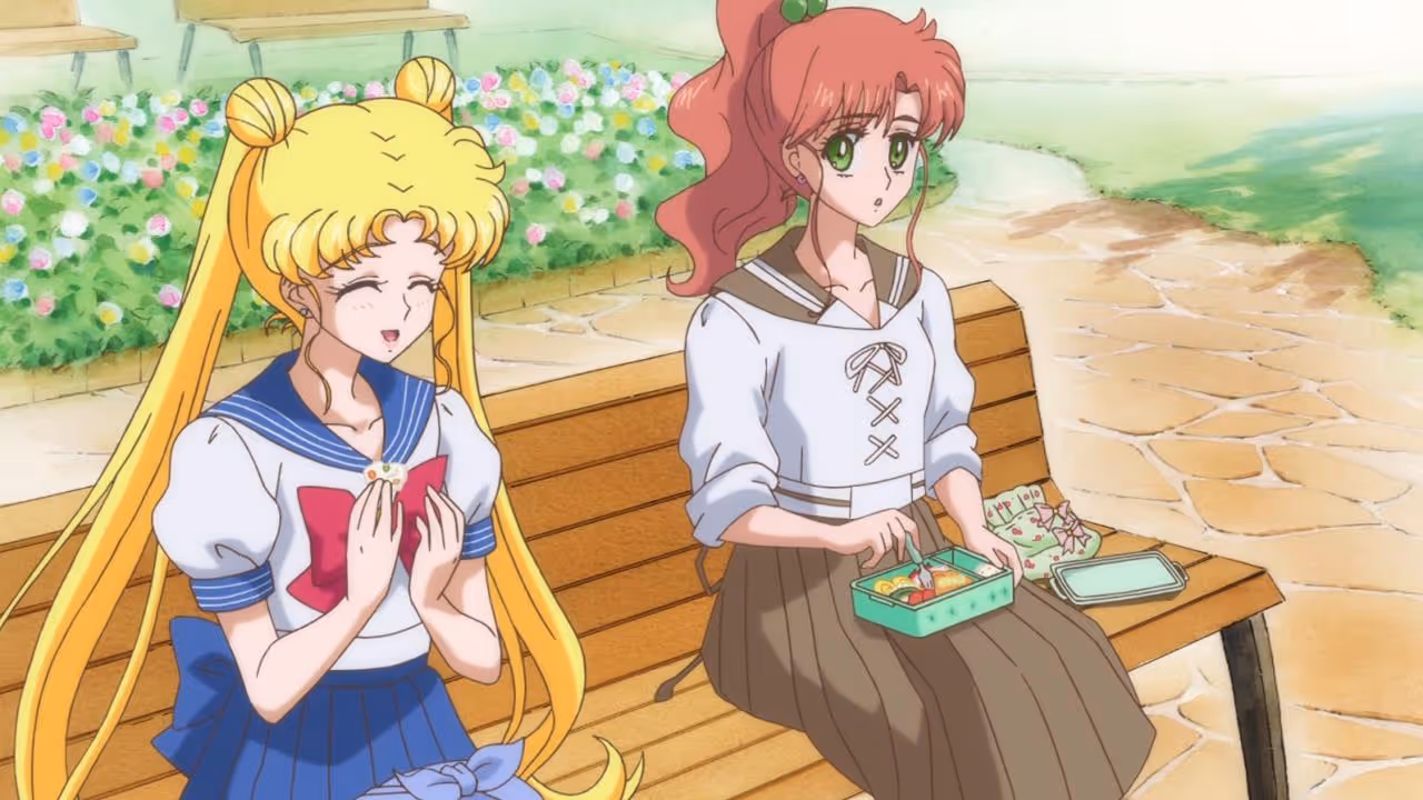 Sailor Moon and Sailor Jupiter eat lunch together on a bench in the Sailor Moon Crystal anime