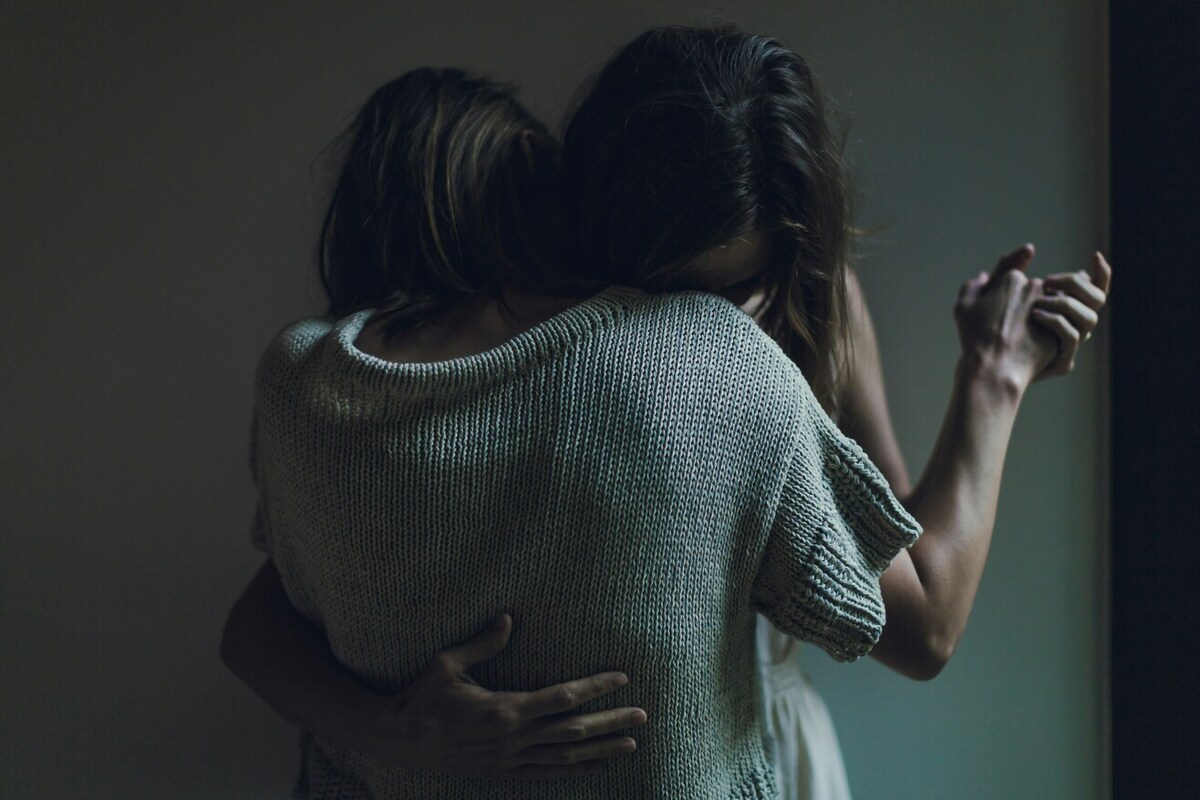 Two people hugging.