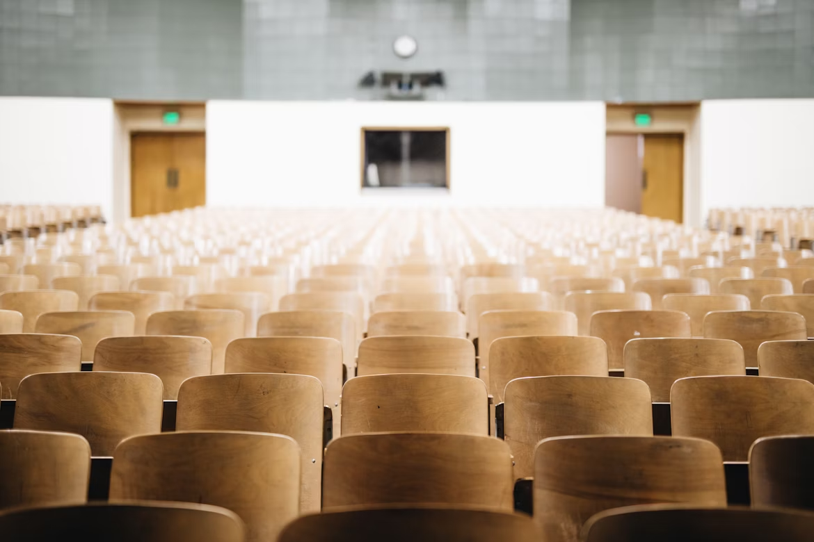 Empty chairs in a school auditorium.