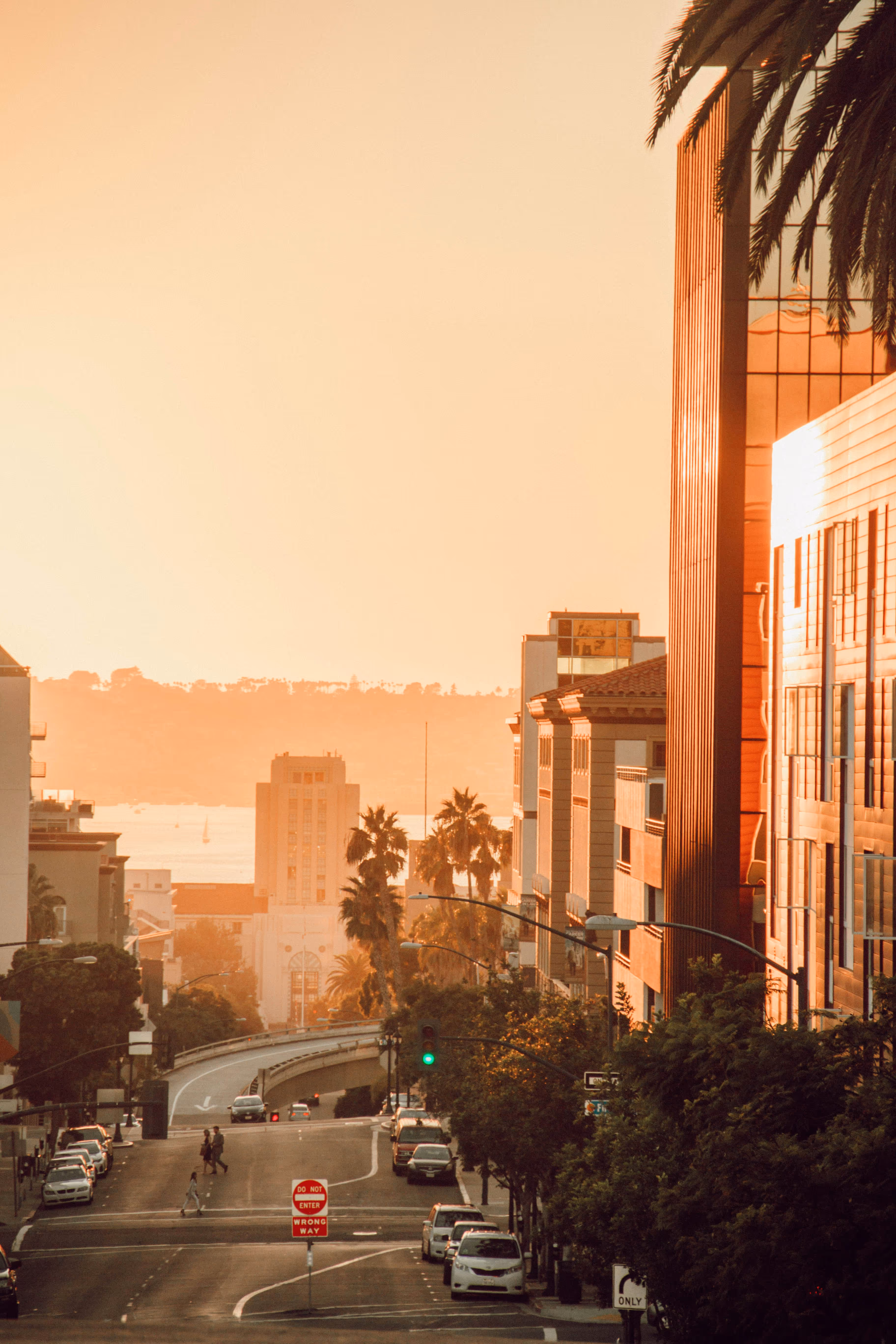 San Diego skyline in an orange tint as the sun sets over the water