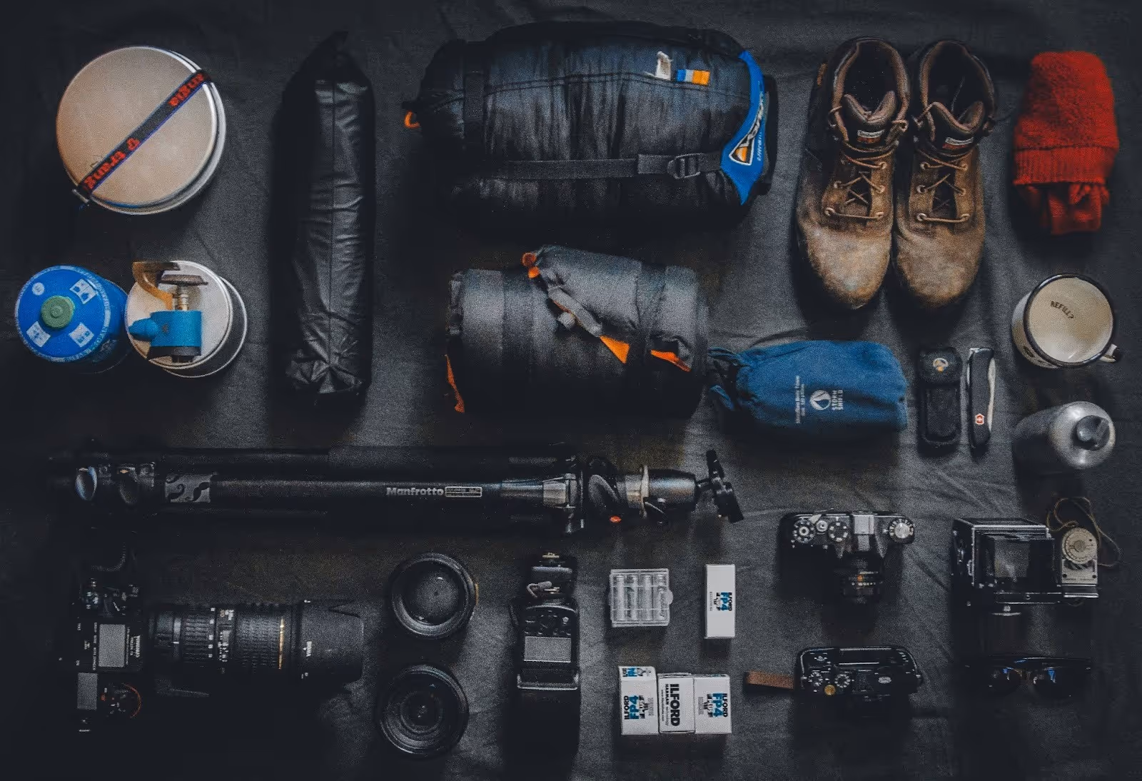 outdoor essentials laid out and ready to pack for his next big adventure