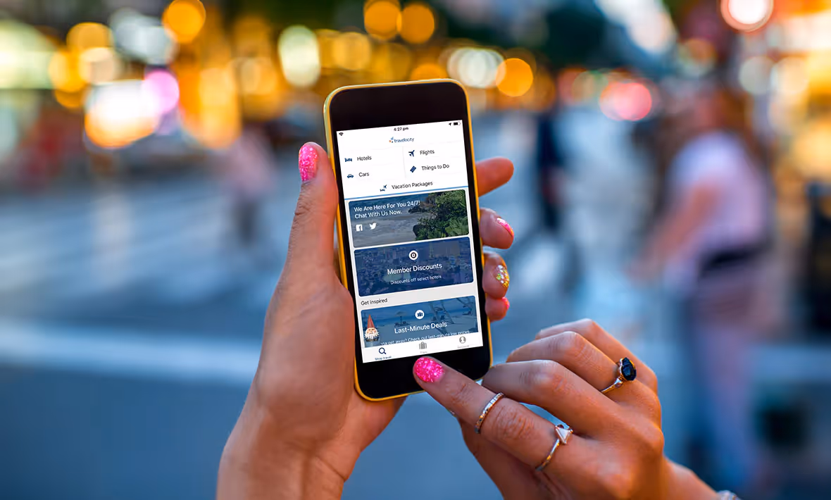 woman checking Travelocity for deals on her phone