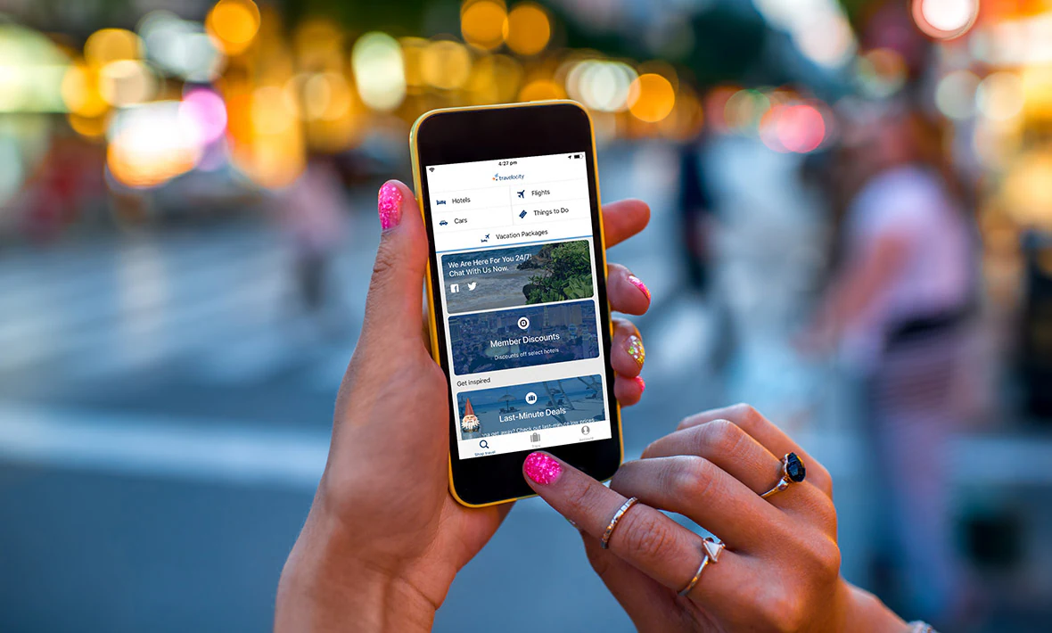 woman checking Travelocity for deals on her phone