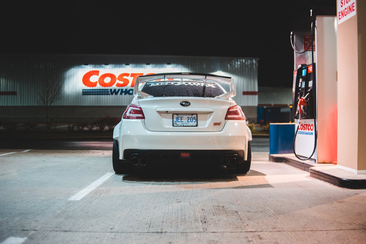 a 20something's car sitting in front of the gas pump at Costco, taking advantage of one of the major benefits of Costco membership for single people