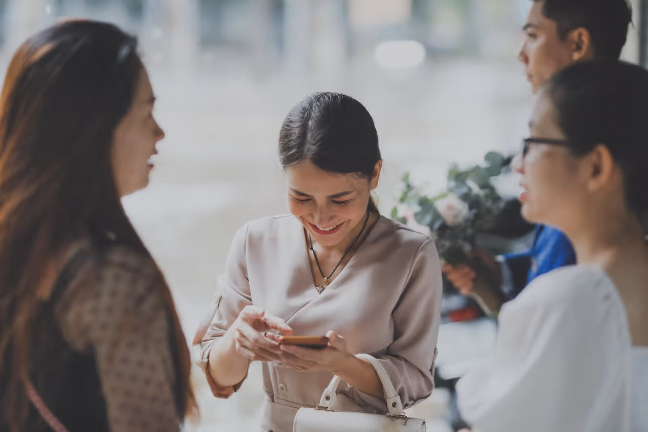female professionals swapping contact information and linkedin profiles at a networking event