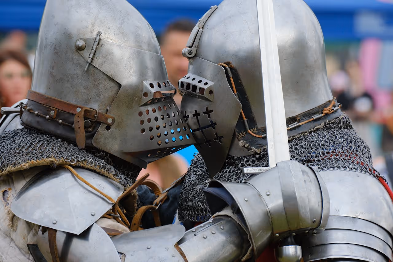 two knights with their helmets pressed together
