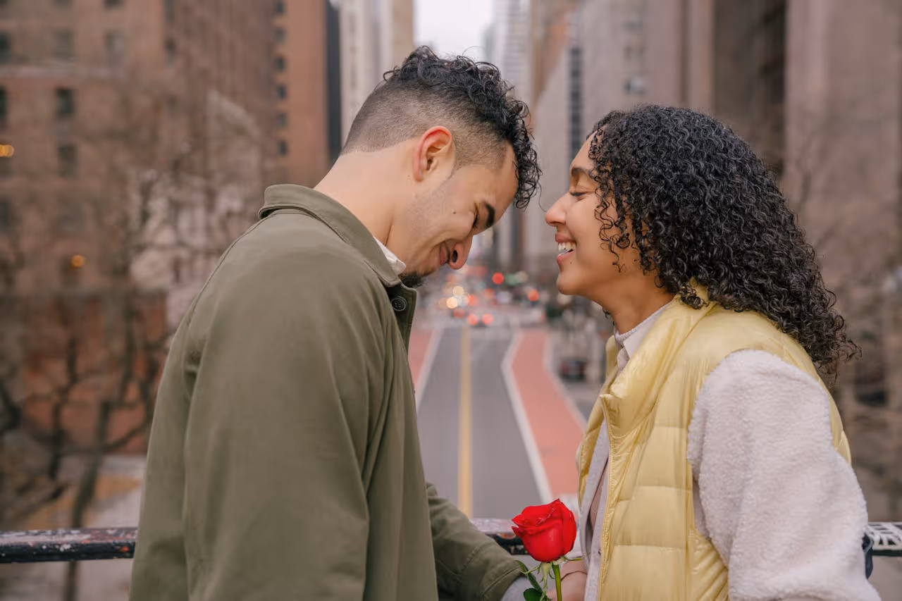 couple smiling and laughing together on a city street