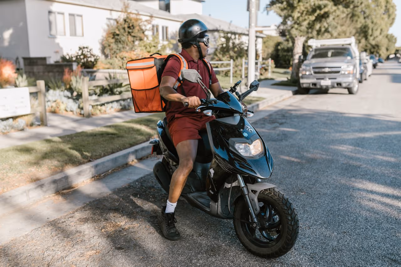 food delivery driver pausing in front of a house