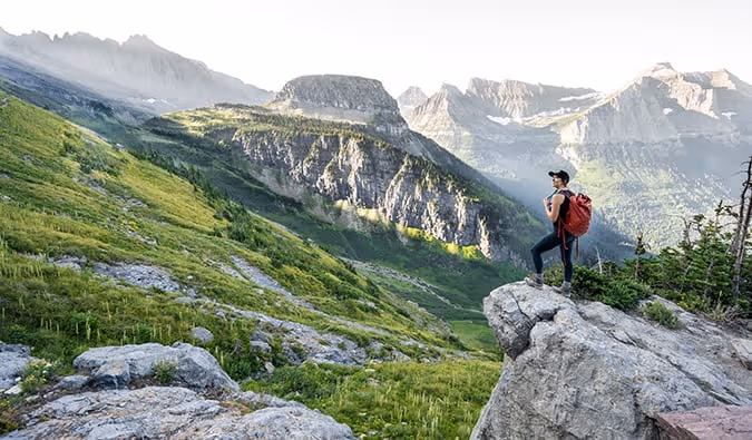 Nomadic Matt looking at a jaw-dropping mountain scene on a solo trip