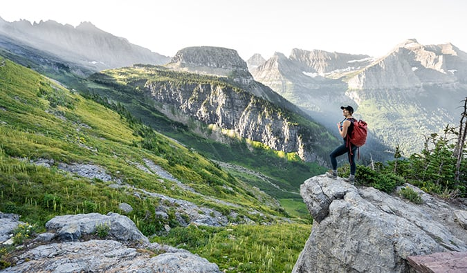 Nomadic Matt looking at a jaw-dropping mountain scene on a solo trip 