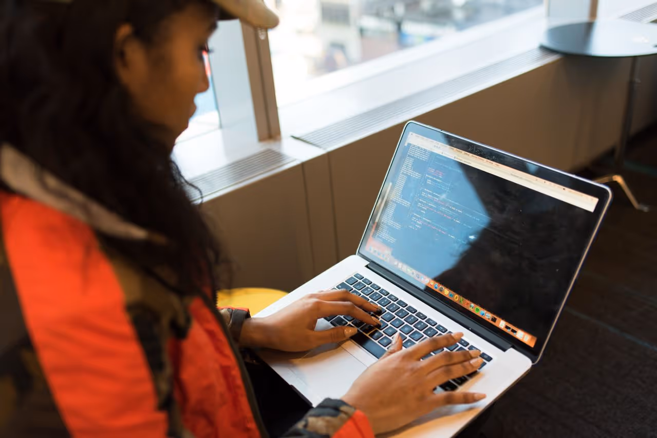 woman learning to code on a laptop