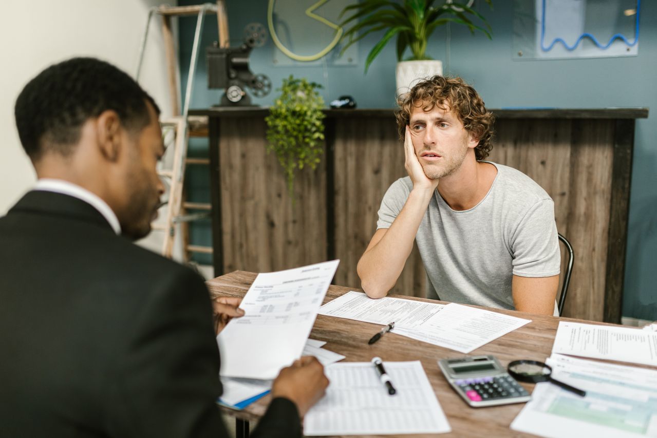man in his 20s getting rejected on an application due to a low credit score