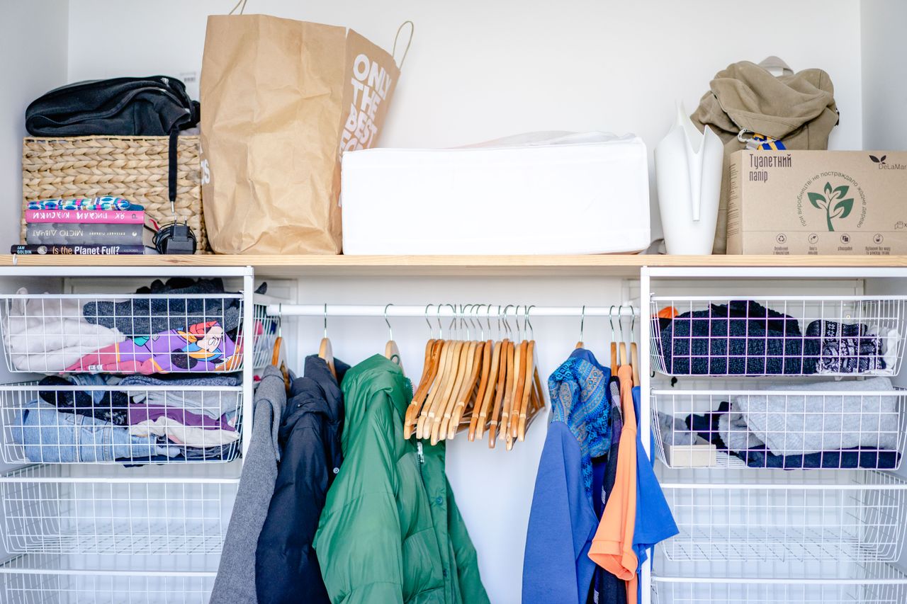 small dorm closet with lots of organizers to maximize the usable space