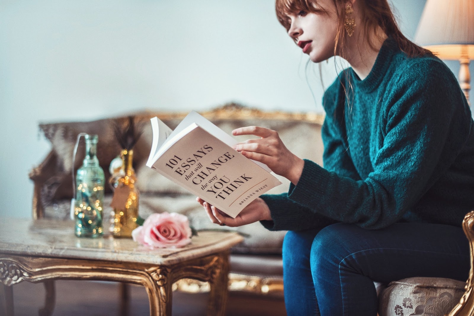 young woman who wants to be well-read reading a book to change how she thinks