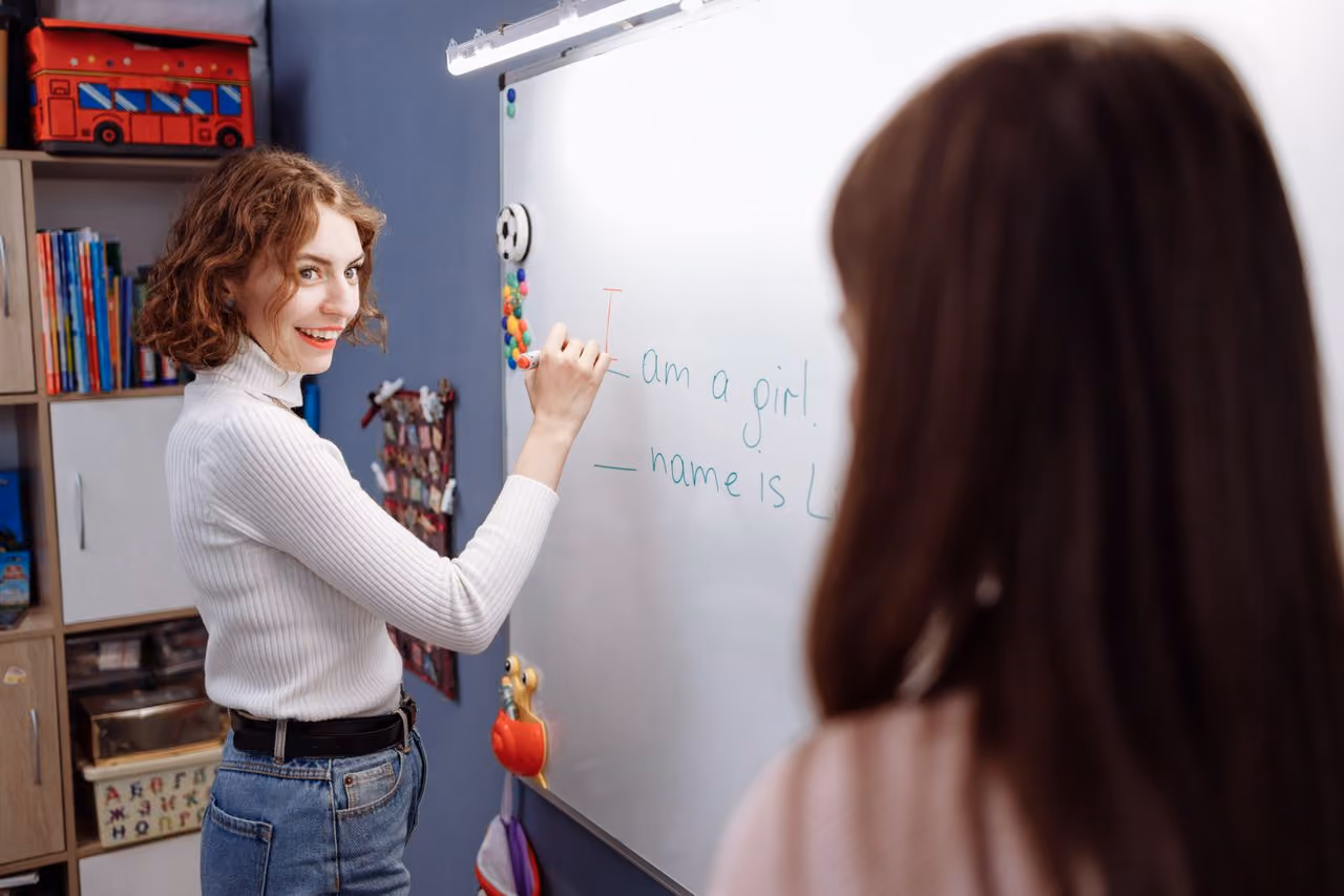 woman learning a foreign language in a classroom, considering switching to one of the best language apps on the market for easier practice and lower prices