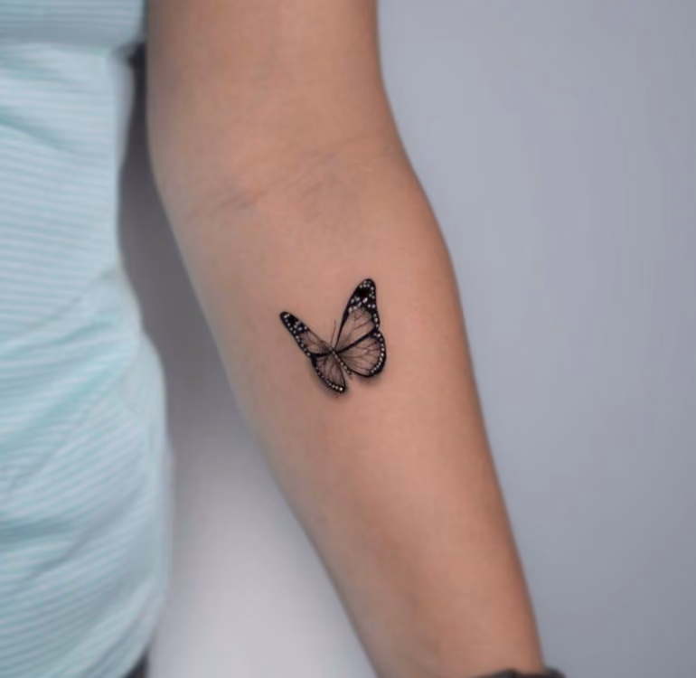 delicate and very realistic butterfly tattoo representing mental health through its association with transformation into somemthing beautiful