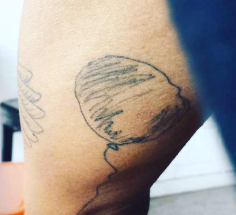 sketchy balloon drawing that represents overcoming a personally difficult night to the artist, which they had tattooed on their body as a reminder of resilience
