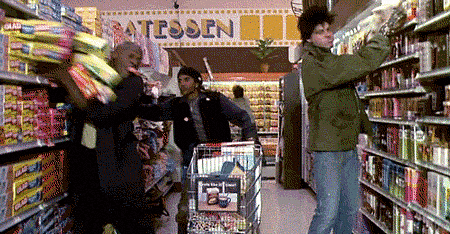 gif of future students shopping the summer before college throwing everything they can get from the shelves into their cartd