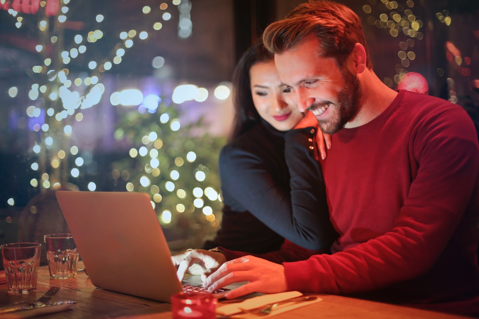 A couple looking at a laptop.