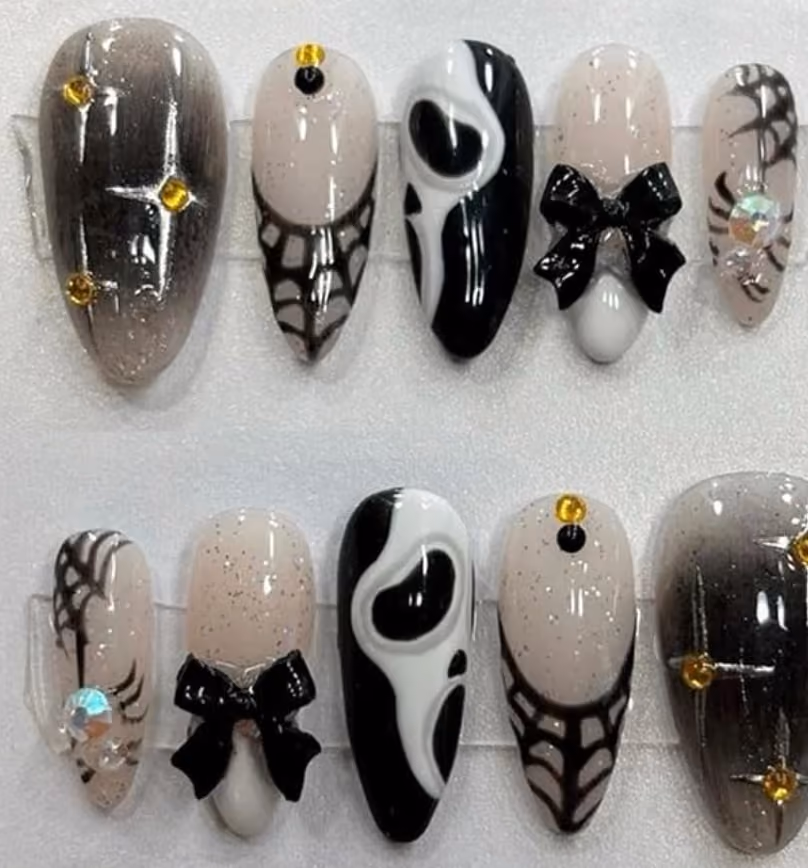 Black, gold, and silver horror movie inspired nail set