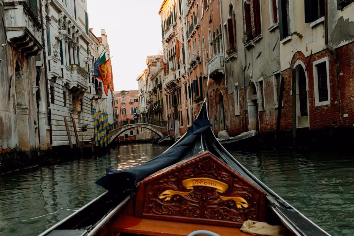 the view from a a gondola in Venice, one of Italy's most iconic destination for first-time and veteran travelers alike