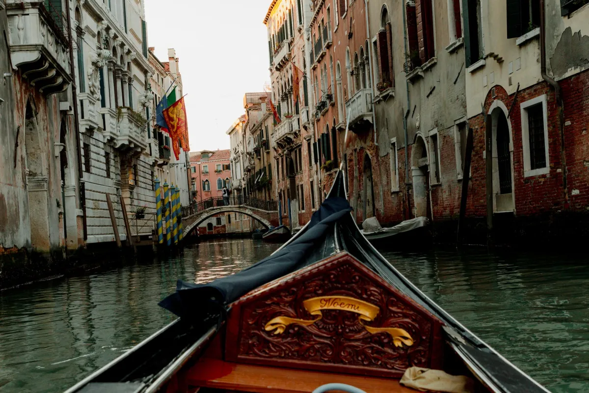 the view from a a gondola in Venice, one of Italy's most iconic destination for first-time and veteran travelers alike