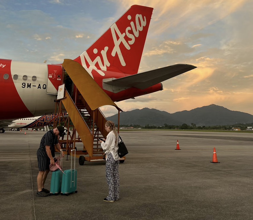 woman checking her bags as she boards a plane for her first international travel experience