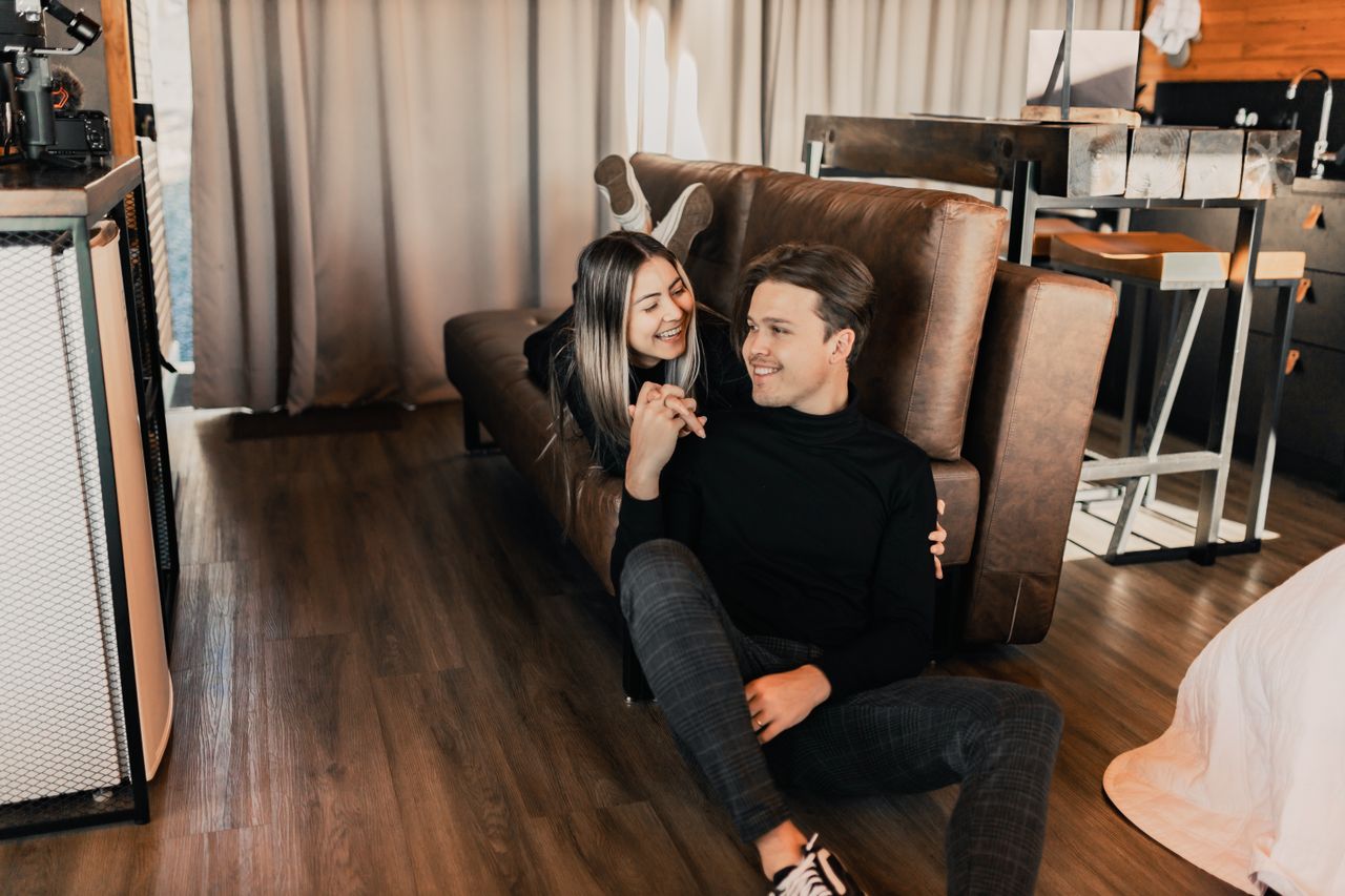 couple reclining on a couch together after moving for the relationship