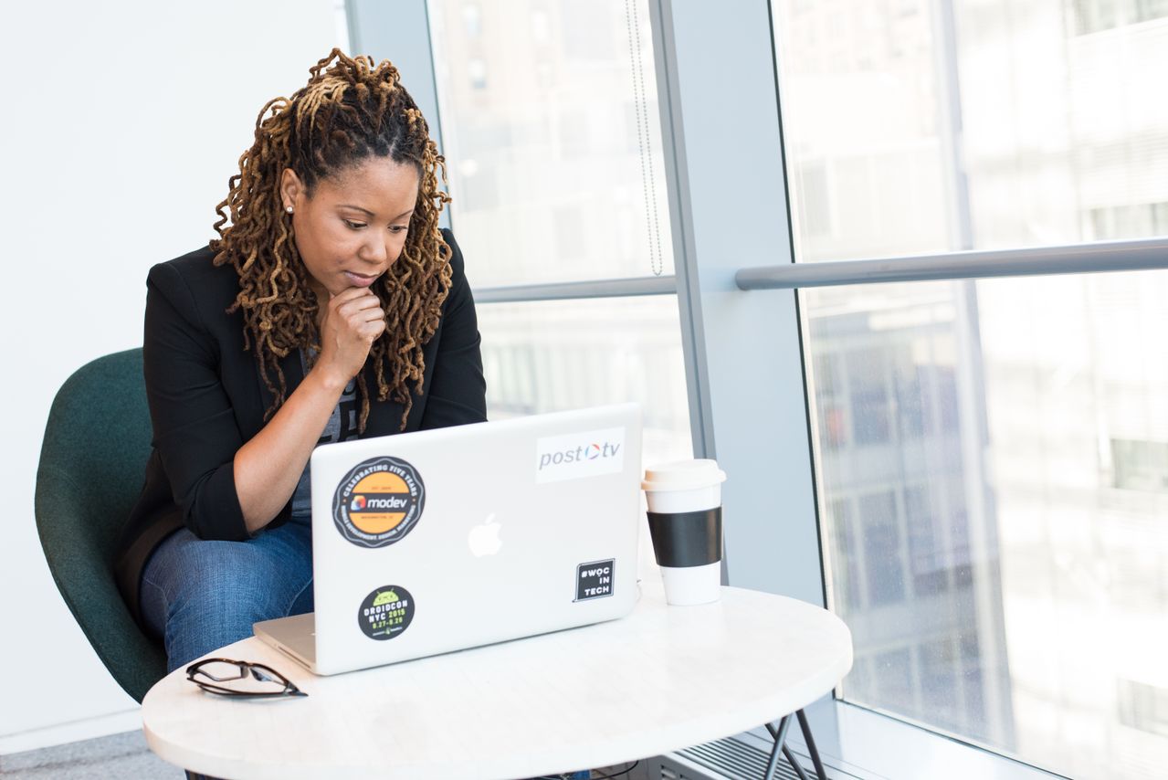 professional woman in a blazer completing a college course online to jumpstart her new career