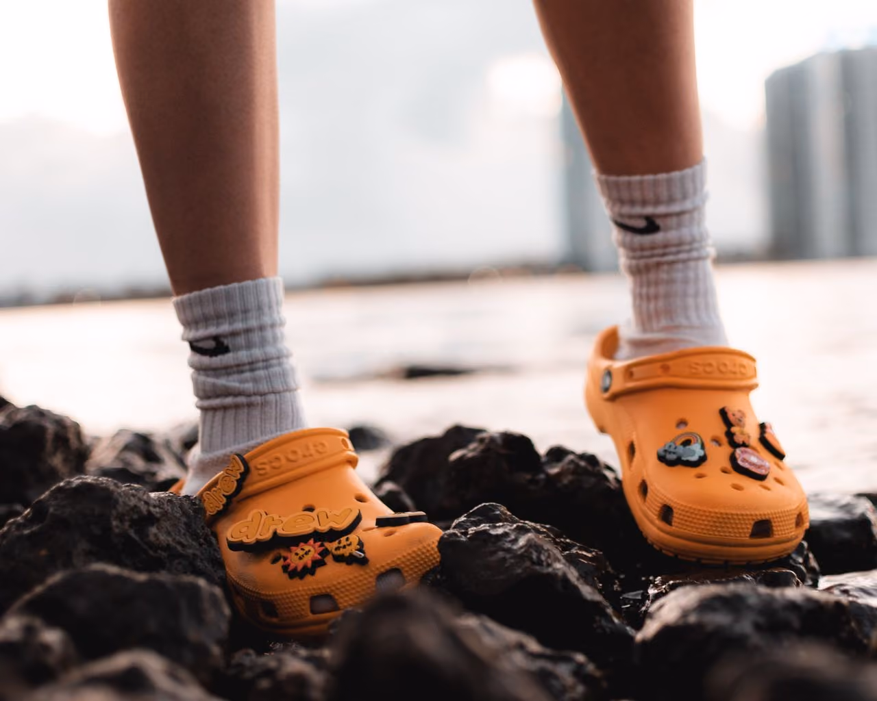hiker wearing grippy Crocs while walking on slippery seaside rocks