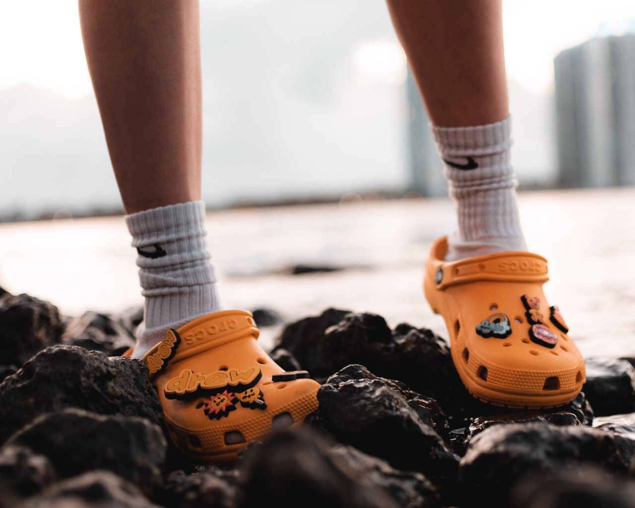 hiker wearing grippy Crocs while walking on slippery seaside rocks