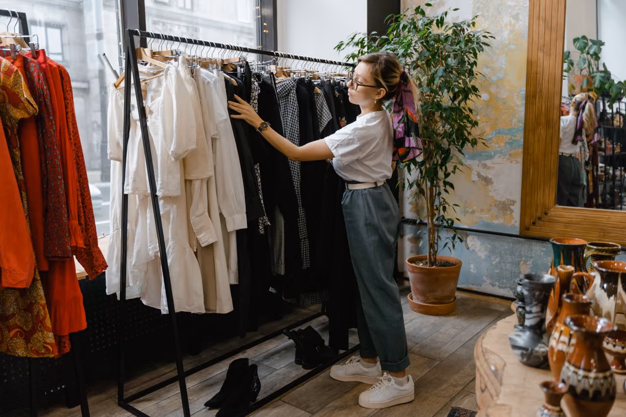 20something sifting through clothing at the store, trying to figure out an aesthetic that works for her