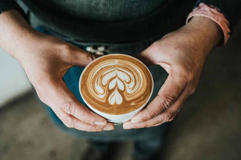 Cup of coffee on a rustic table, highlighting caffeine’s effect on anxiety and the importance of mindful consumption