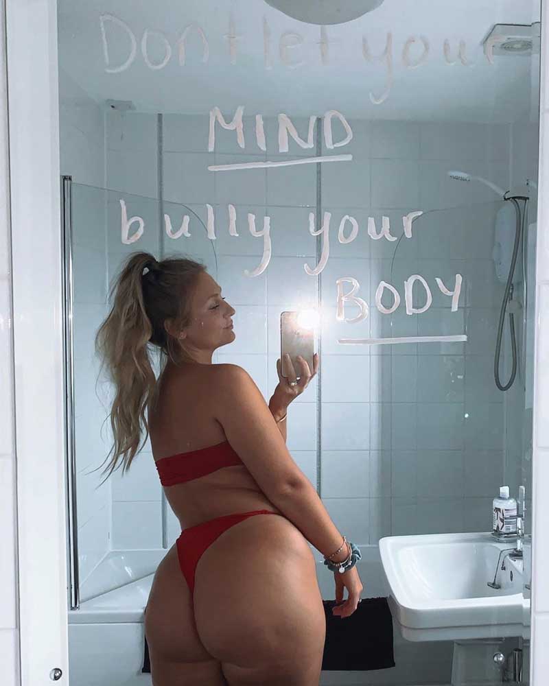 Sophie in a stylish red swimsuit, photographed from front and back at the shore