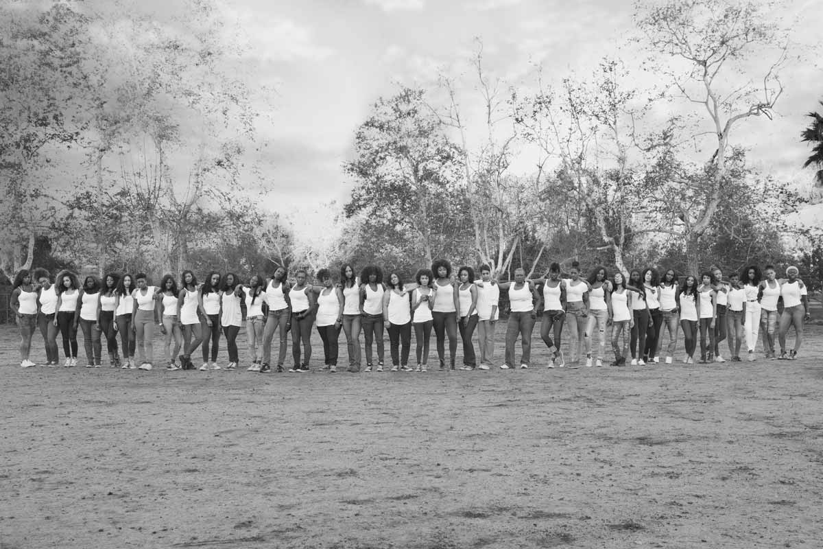 Group photo of 40 Black women celebrating body positivity and sisterhood in a park