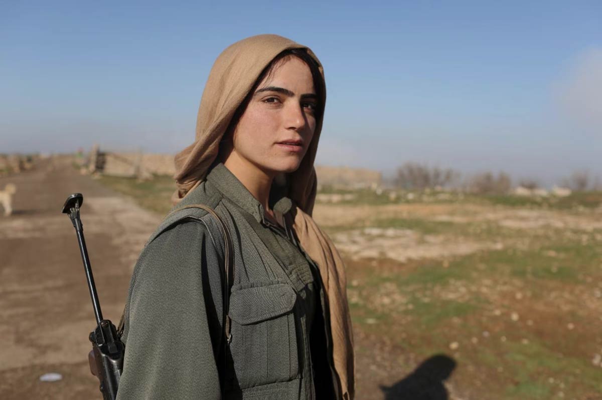 A female Kurdistan Workers Party (PKK) fighter stands near a security position in Sinjar, March 13, 2015. REUTERS/Asmaa Waguih
