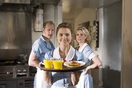 Scene from The Waitress featuring Jenna, a small-town waitress with a talent for baking extraordinary pies, dreaming of winning a $25,000 contest to escape her difficult marriage and open her own pie shop. The film follows her journey toward happiness and self-empowerment after meeting a charming newcomer.