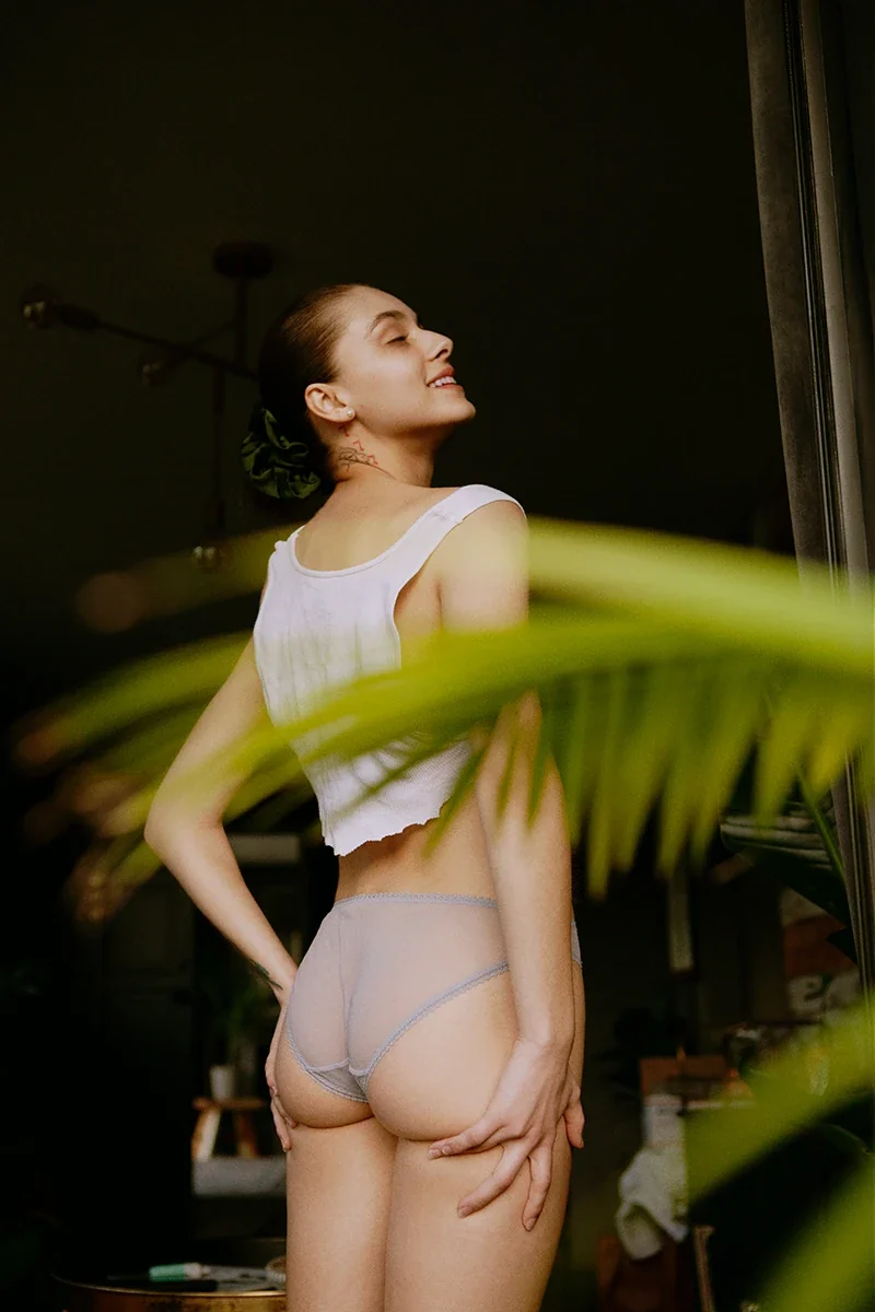 Angelina Love smiling over her shoulder, radiating body confidence and joy