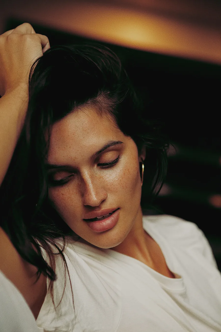 Black and white image of Bare Model Alejandra revealing her natural silhouette during an unfiltered indoor photoshoot.