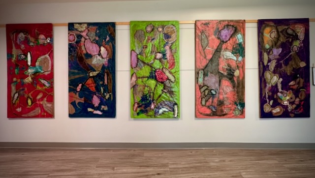 All five art pieces hanging on the wall in gallery view.