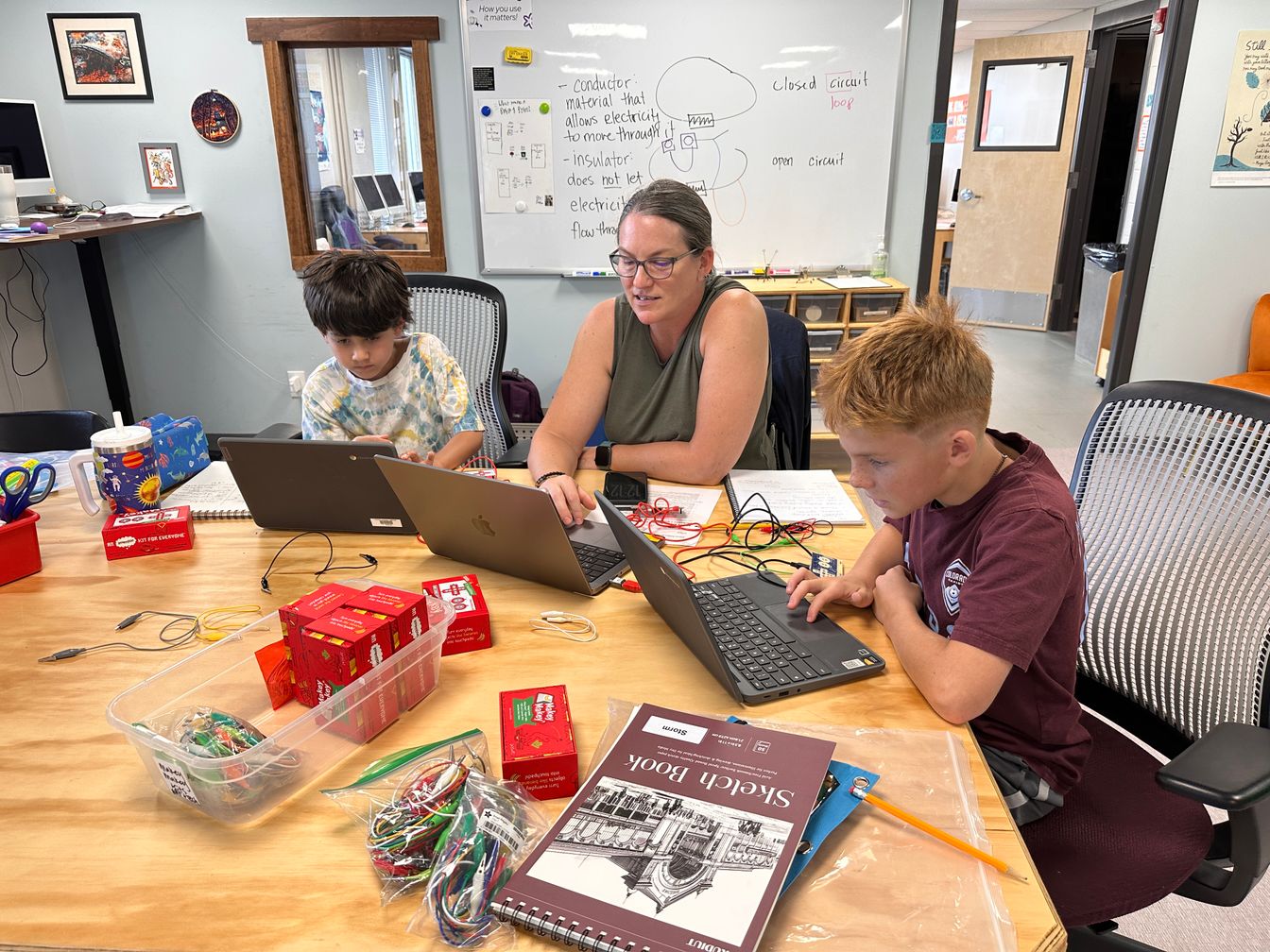 Students in tech lab working on coding a robot