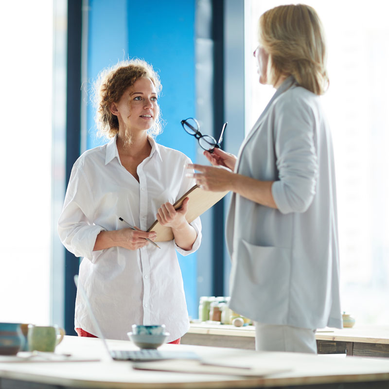 Photo of two female executives in conversation