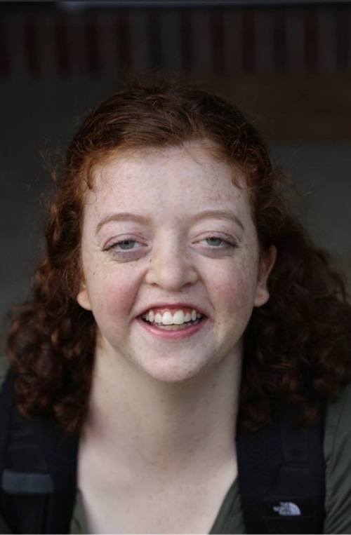 Headshot of Catherine Harris, a white woman with shoulder length hair.