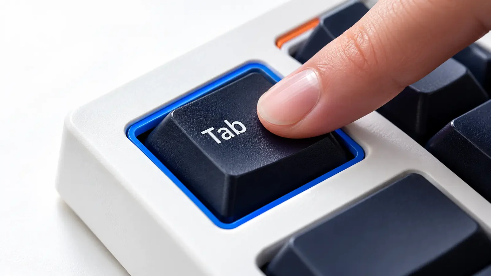 Finger pressing a Tab key outlined in blue on a white keyboard, illustrating keyboard accessibility.