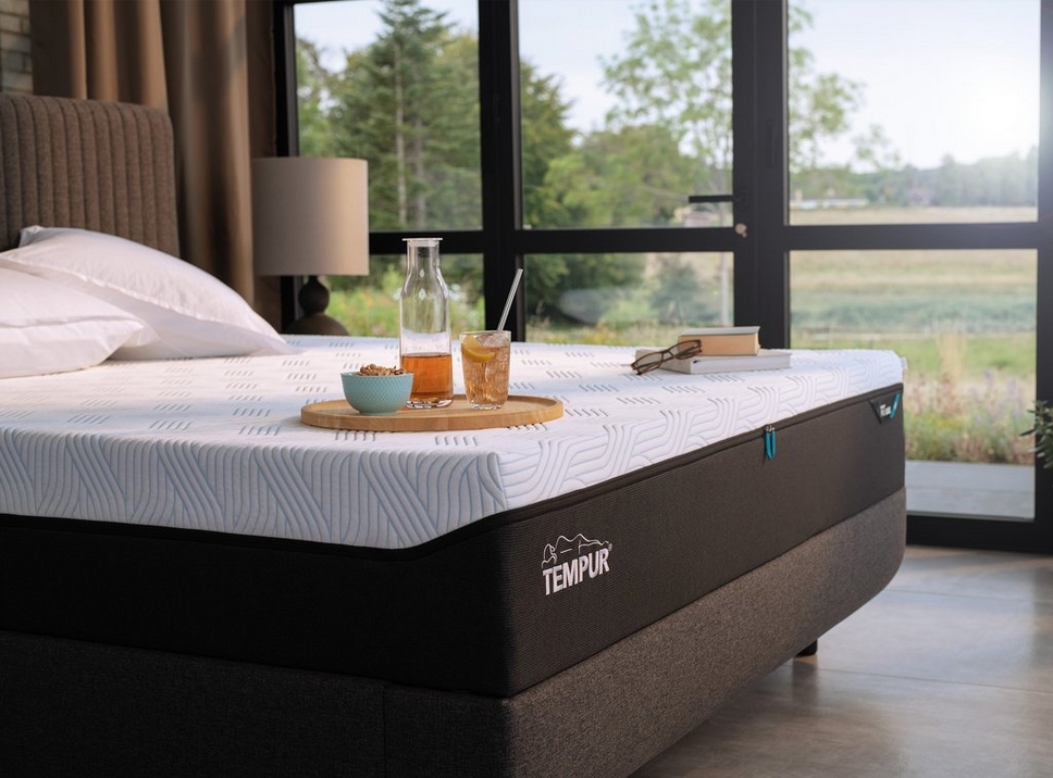 A Tempur Pro SmartCool Mattress in a bedroom setting with breakfast & juice on a tray 