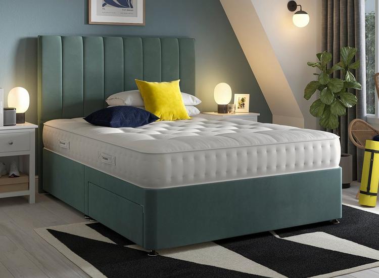 A Dreams Brookfield Mattress on a green bed frame with matching headboard with cushions on the bed