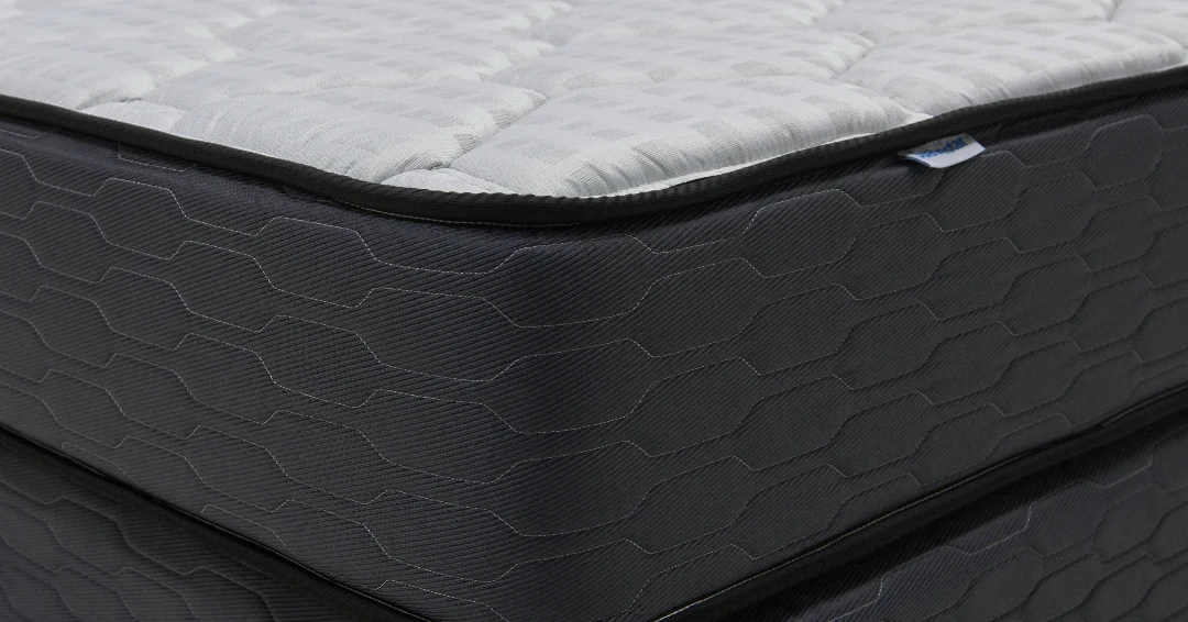 A deep pocket-sprung mattress with a reinforced edge on a sturdy slatted bed frame