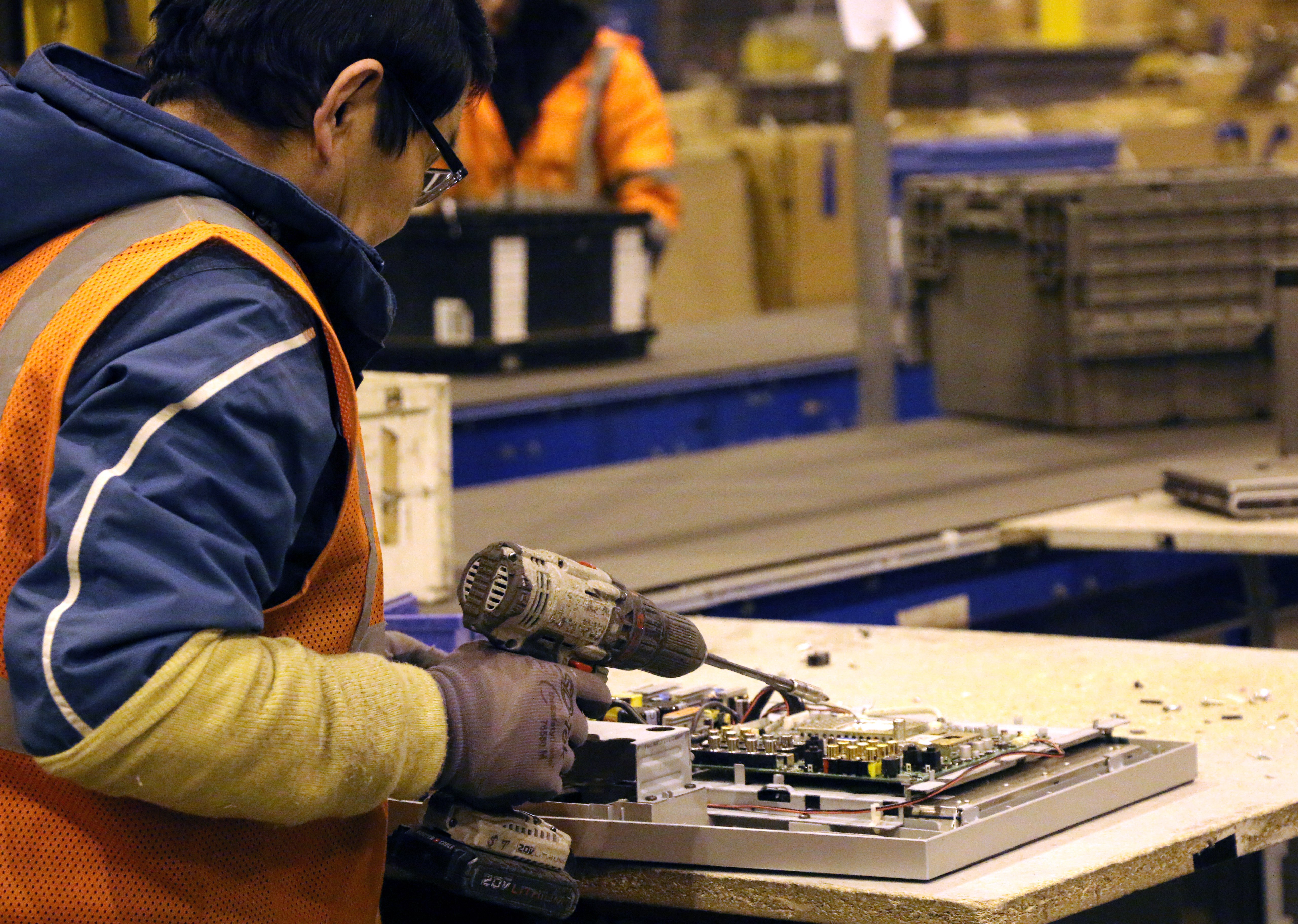 Photo of a man dismantling electronics