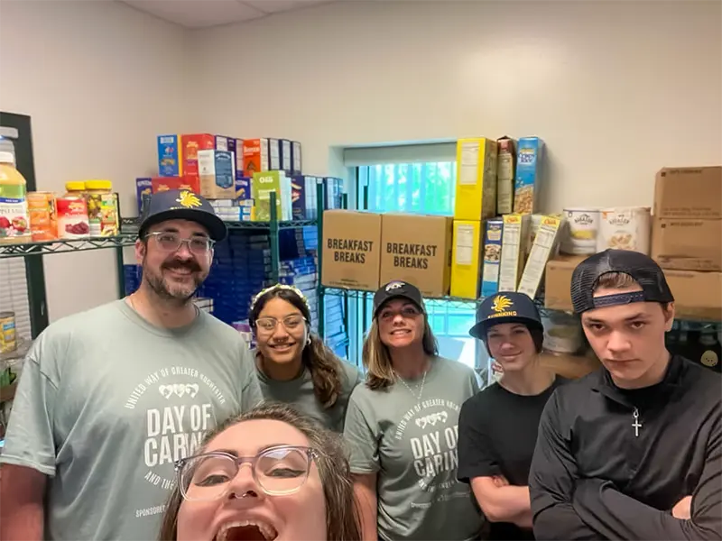 Sunnking Crew celebrating their successful reorganization of the food pantry at Rochester's House of Mercy.